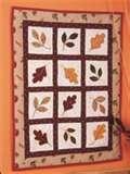 Another lovely fall quilt with various autumn leaf appliques