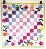 Anna Whorl has been busy .Here is another completed wall quilt.  I used the flower, stem, and leaf die cuts I ordered from you as well as a few yoyo's and button centers. May 2012