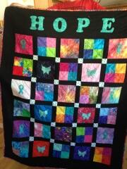 2016, Jan. - Linda also made this vibrant "HOPE" quilt using ribbon & butterfly appliques for Ovarian Cancer